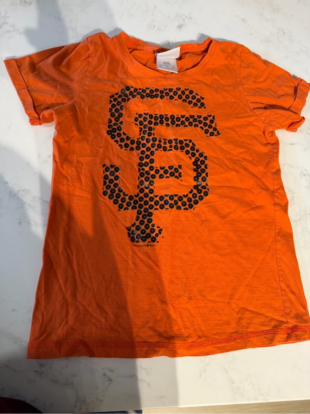 5th & Ocean Orange Short Sleeve Tee with Black Stud Graphic